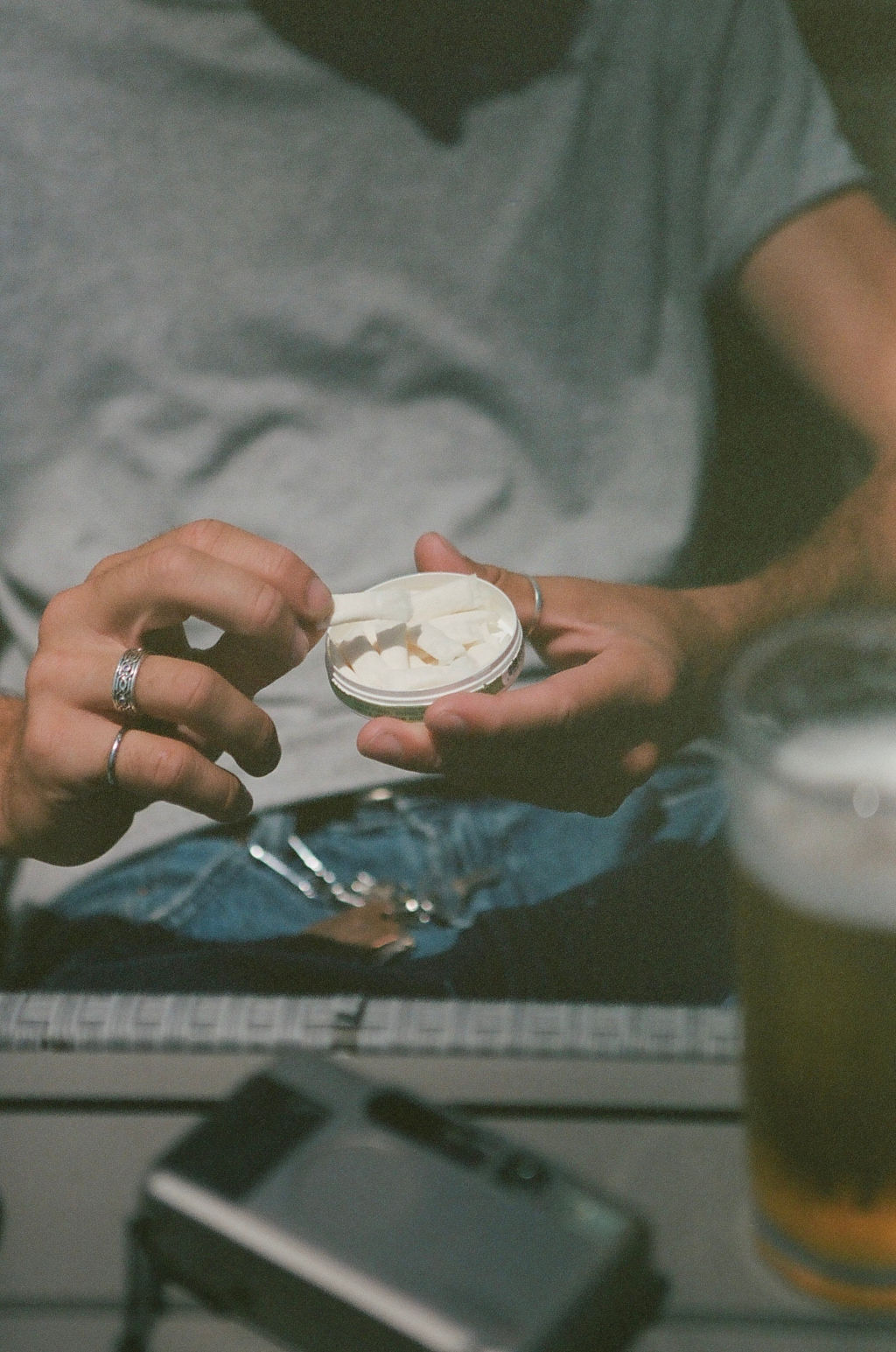 Person holding an open pouch container.