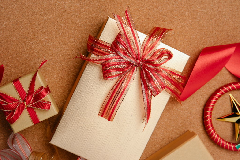 Wrapped gifts with a red ribbon bow.