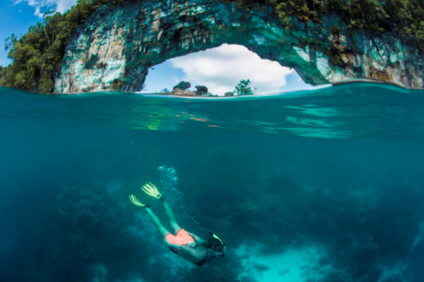 Free Diver Below Stone Arch